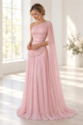 Blush pink Graceprom chiffon wedding guest dress with a beaded one-shoulder bodice, dropped waist, flowing A-line skirt and floor-length sheer cape.