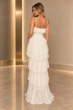 Back view of ivory chiffon prom dress featuring spaghetti straps, low straight back, center zipper and flowing tiered ruffle A-line skirt