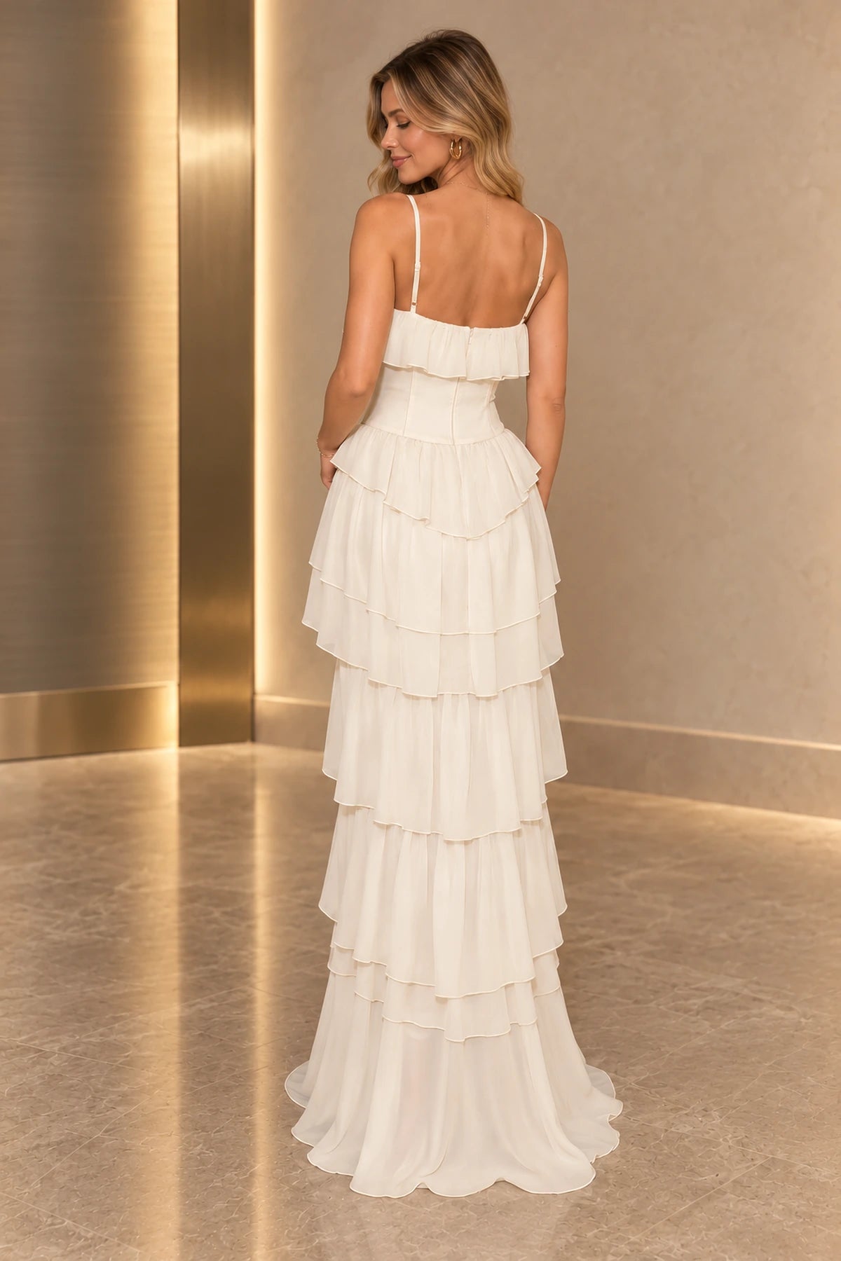 Back view of ivory chiffon prom dress featuring spaghetti straps, low straight back, center zipper and flowing tiered ruffle A-line skirt