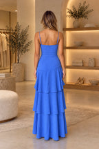 Back view of royal blue chiffon prom dress featuring spaghetti straps, straight low back, center zipper, fitted drop waist and cascading ruffle skirt