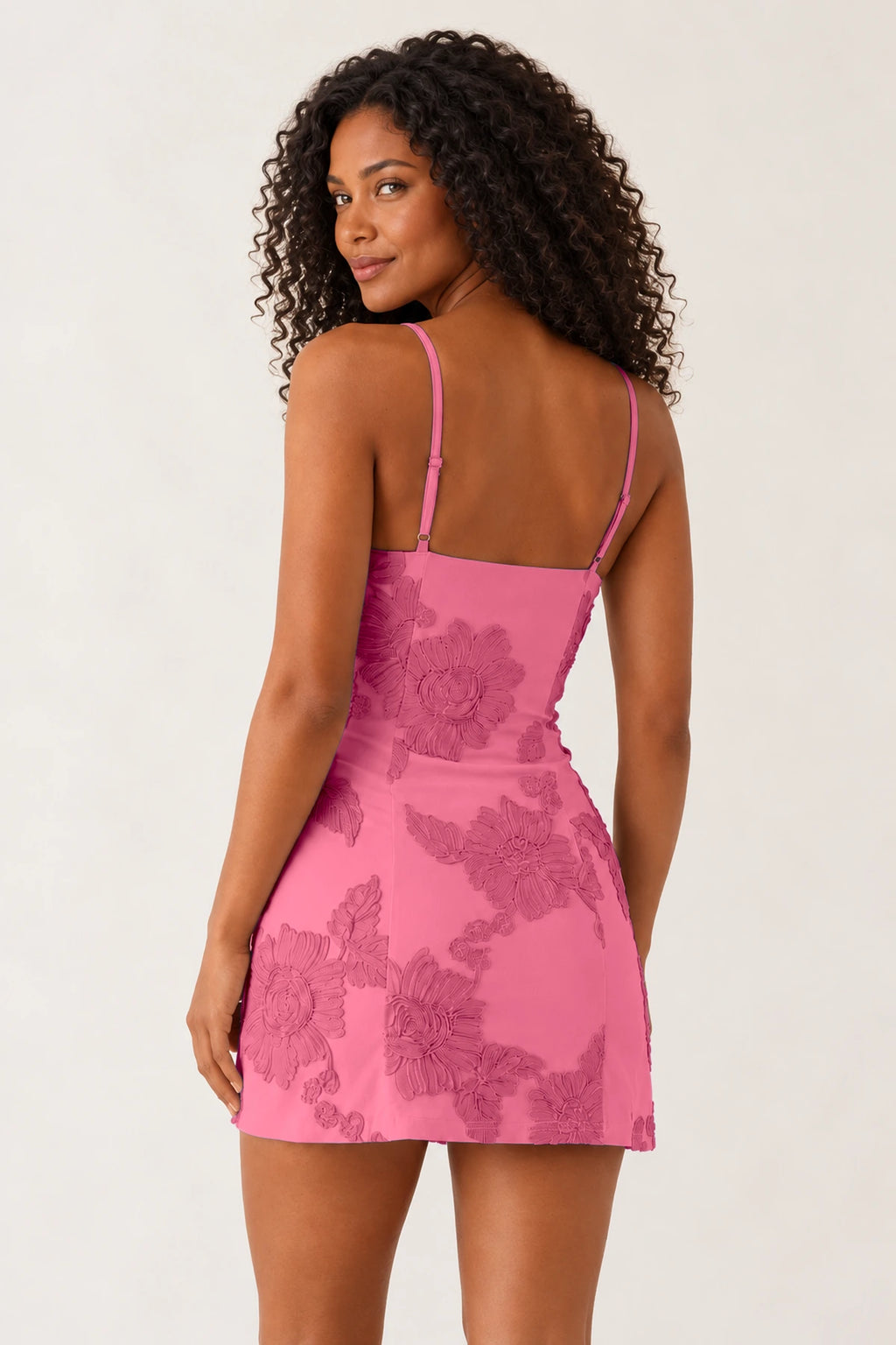 Coral pink floral fitted mini homecoming dress with spaghetti straps back view by Graceprom