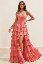 Coral pink A-line prom dress featuring a strapless sweetheart corset bodice, tiered chiffon-look ruffles, front slit, and floor-length skirt by Graceprom.