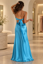 Deep purple satin prom dress with open back detail and elegant floor length silhouette