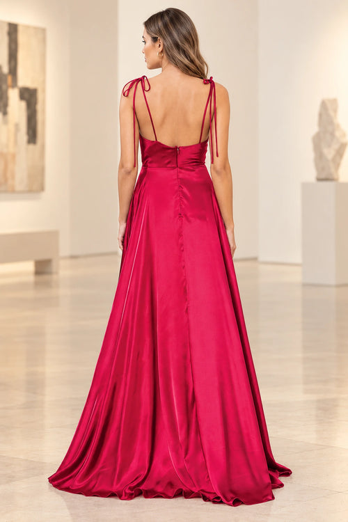 Deep red prom dress showing shoulder tie bows, thin back straps, a low curved neckline, center zipper, and flowing floor-length skirt.