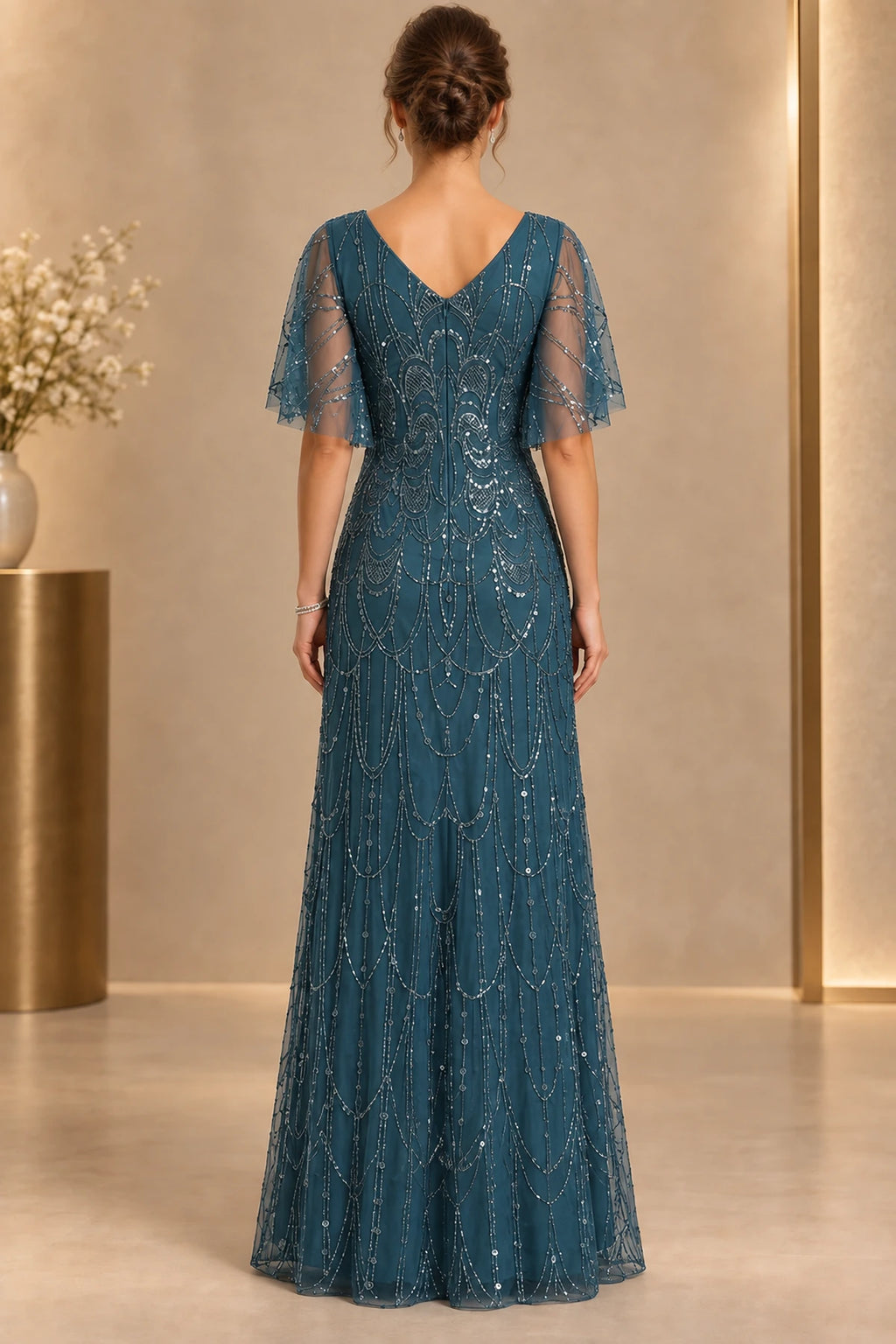 Deep teal mother of the bride dress with V back flutter sleeves and elegant beaded long skirt
