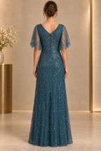 Deep teal mother of the bride dress with V back flutter sleeves and elegant beaded long skirt