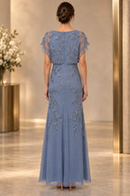 Back view of dusty blue mother of the bride dress with cape sleeves and leaf beaded embellishment