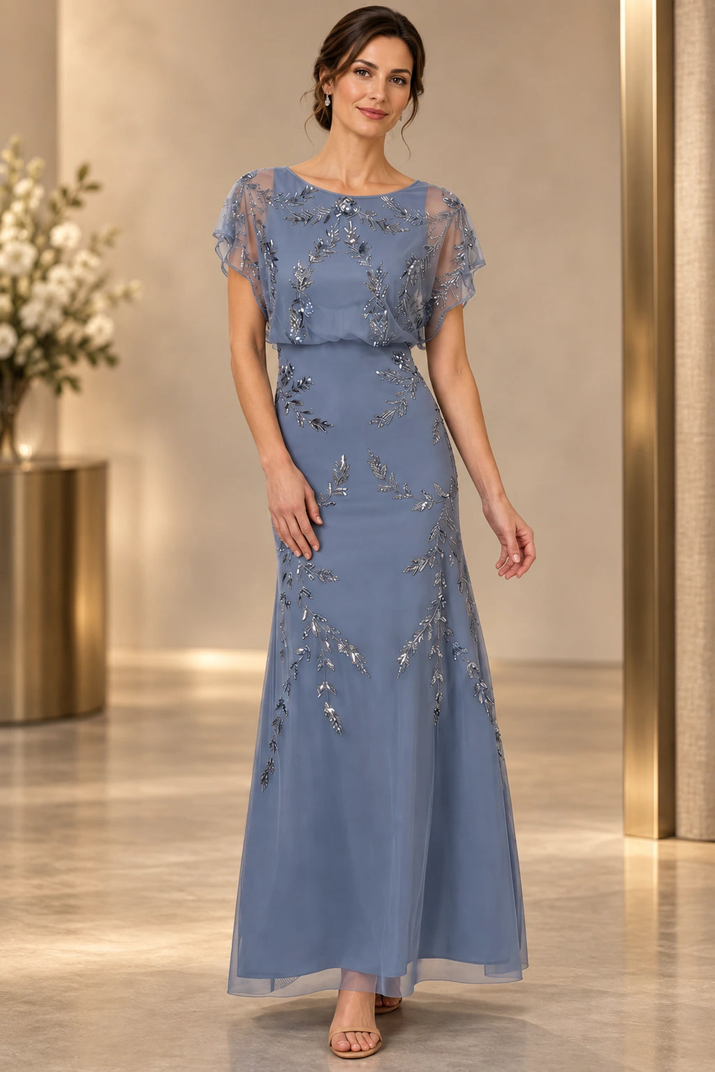 Dusty blue mother of the bride dress with illusion neckline cape sleeves and silver beaded detail