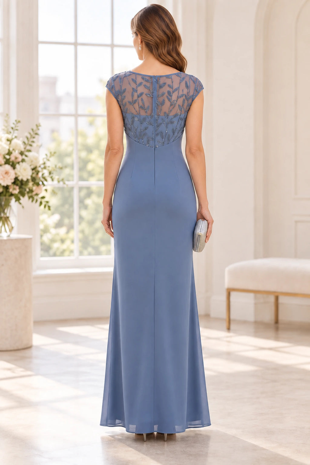 Back view of dusty blue Mother of the Bride Dress with sheer embroidered back, cap sleeves and floor-length sheath skirt