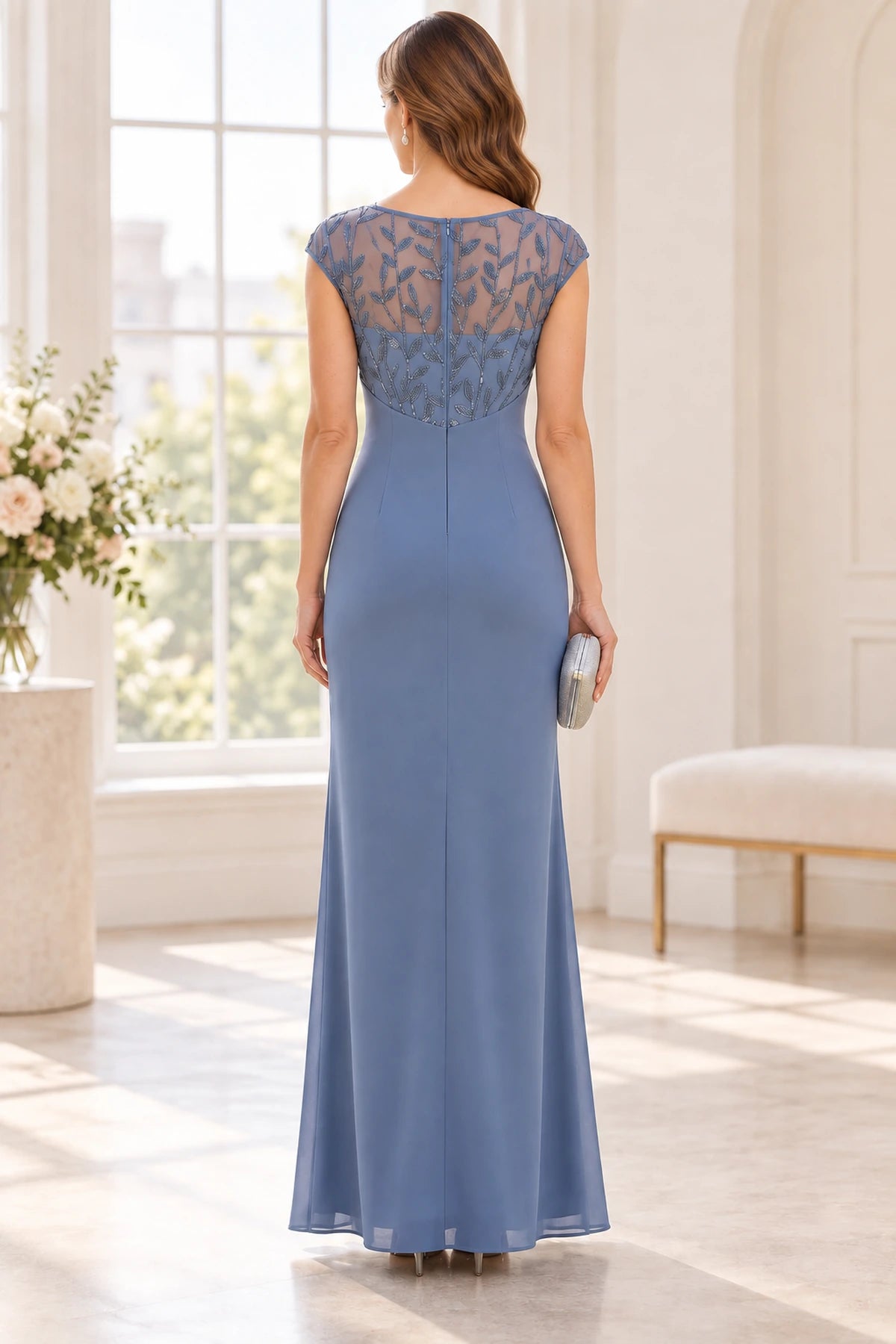 Back view of dusty blue Mother of the Bride Dress with sheer embroidered back, cap sleeves and floor-length sheath skirt