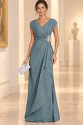 Dusty blue Mother of the Bride Dress with V-neck, pleated bodice, floral waist detail and flowing floor-length skirt