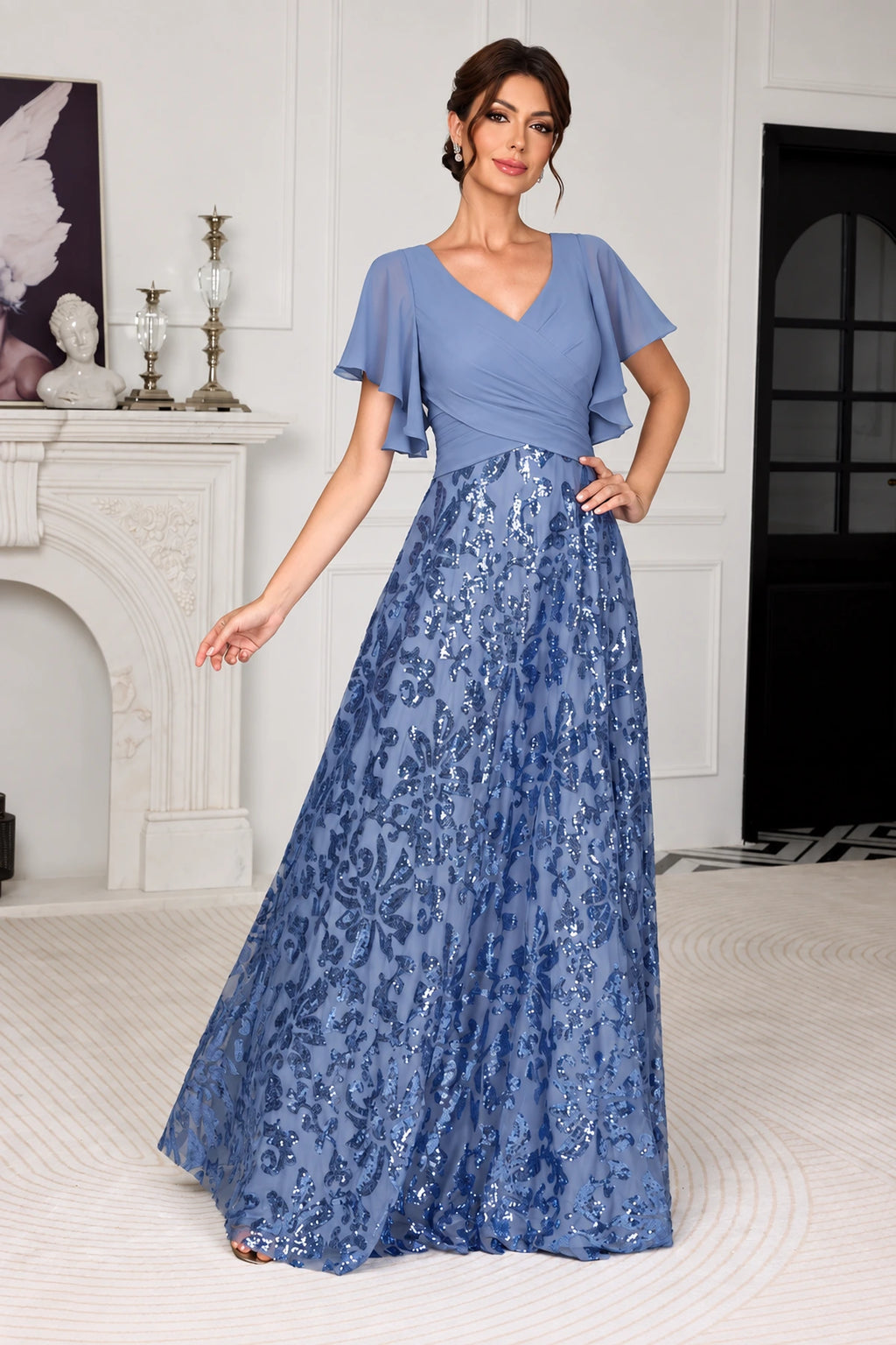 Dusty blue mother of the bride dress with V-neck flutter sleeves ruched bodice and sequin A-line floor-length skirt