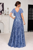 Dusty blue mother of the bride dress with V-back flutter sleeves and sparkling floor-length A-line skirt