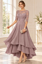 Dusty mauve mother of the bride dress with lace bodice three quarter sleeves and layered chiffon skirt