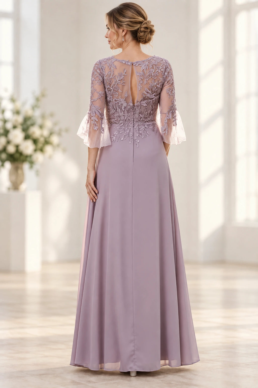 Back view of dusty mauve Mother of the Bride Dress with lace appliqué bodice, keyhole back and floor-length skirt