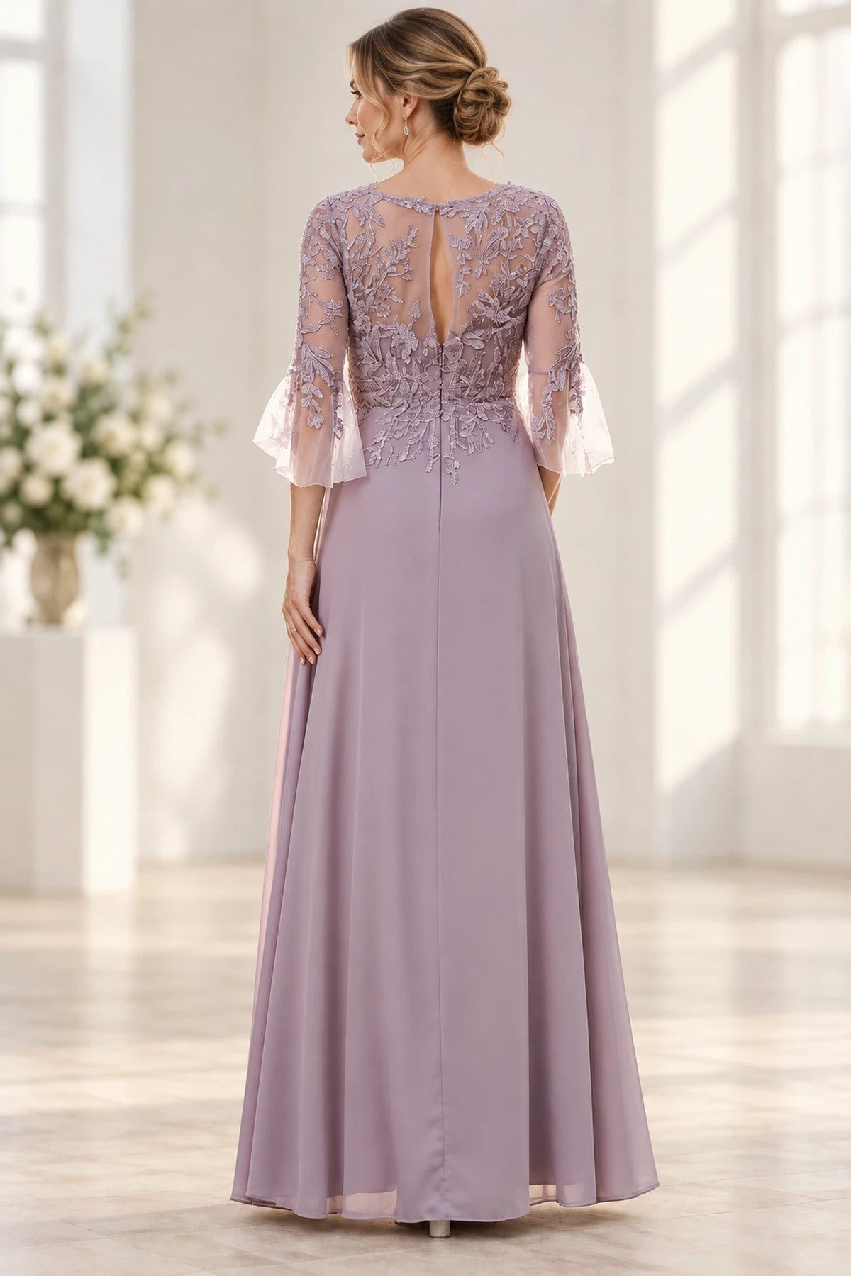 Back view of dusty mauve Mother of the Bride Dress with lace appliqué bodice, keyhole back and floor-length skirt