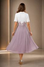 Vedress ivory and dusty mauve mother of the bride dress with short sleeves lace waist zipper back and tea-length A-line skirt back view