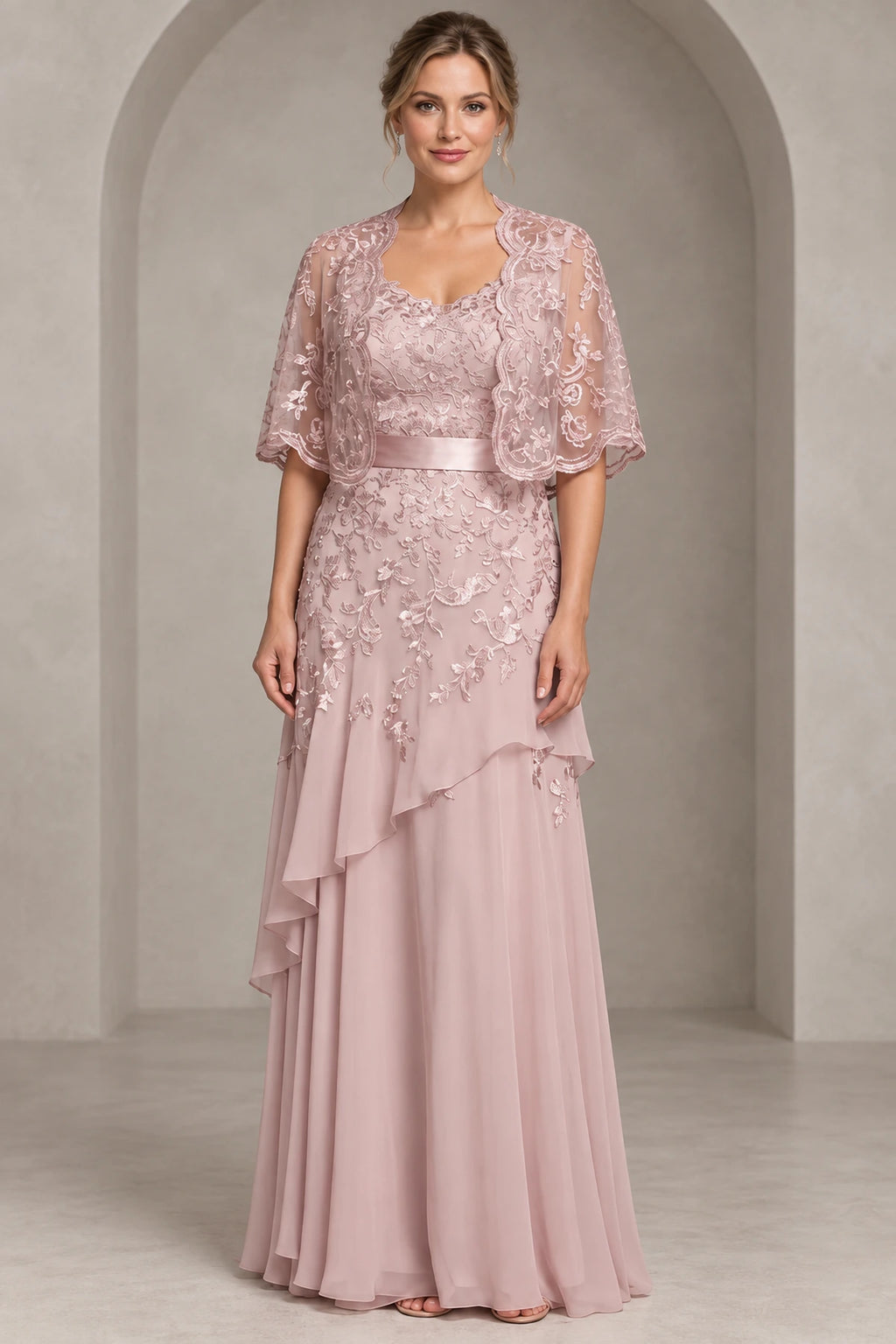 Dusty rose A-line Mother of the Bride Dress with sweetheart neckline, lace cape overlay, satin waistband and layered floor-length chiffon skirt