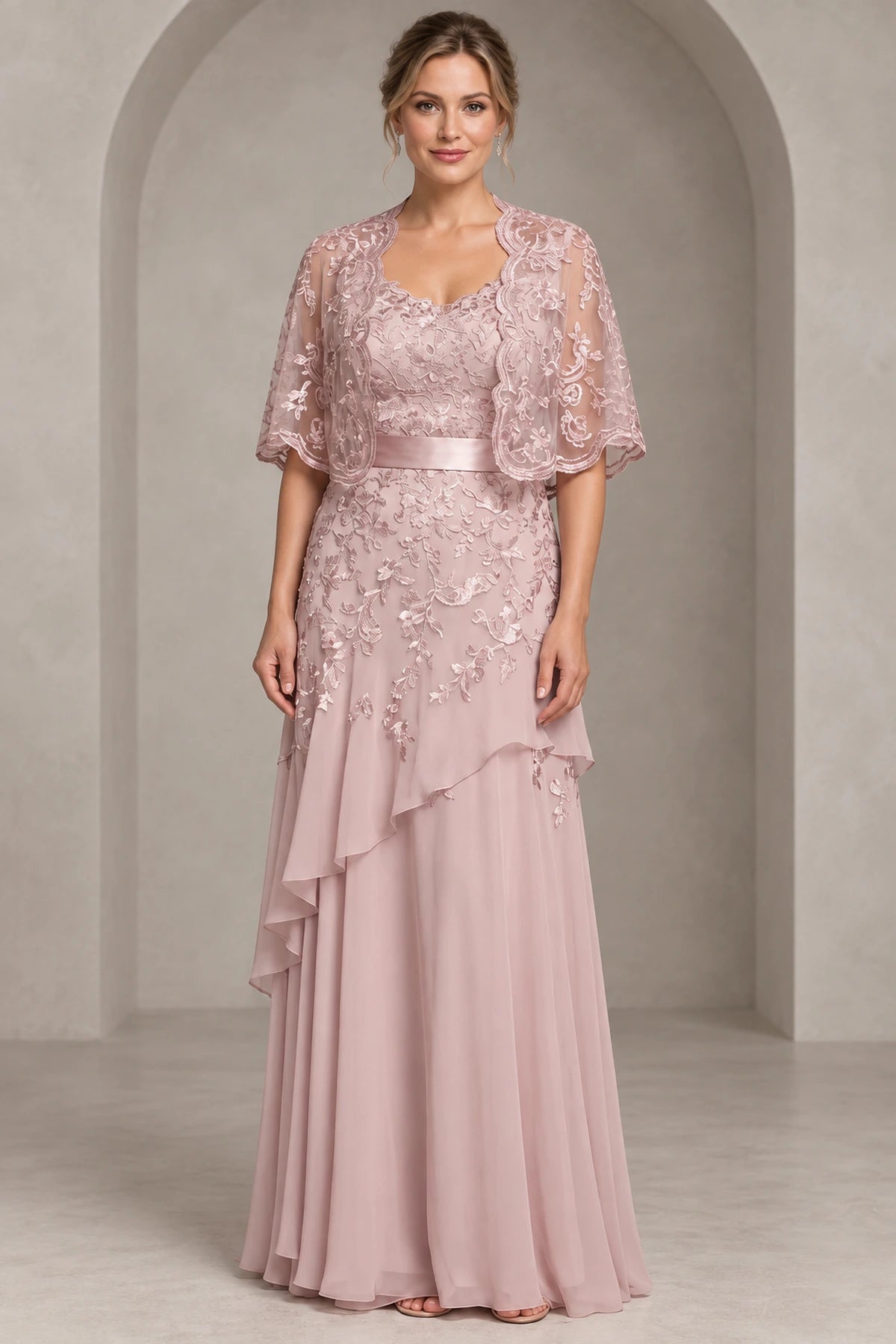 Dusty rose A-line Mother of the Bride Dress with sweetheart neckline, lace cape overlay, satin waistband and layered floor-length chiffon skirt