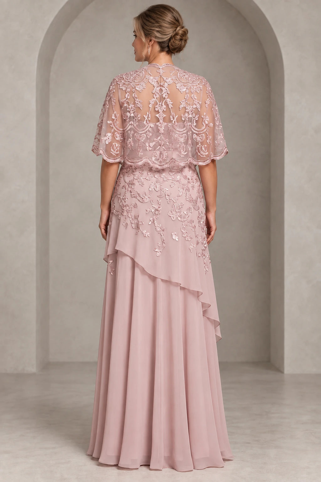 Back view of dusty rose Mother of the Bride Dress with floral illusion lace cape, sheer back and layered chiffon floor-length skirt