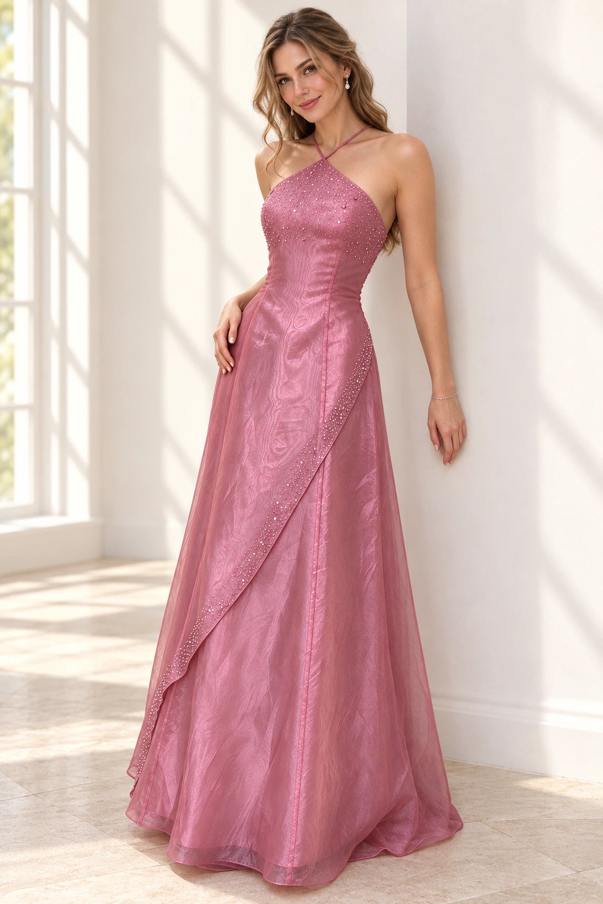 Elegant dusty rose chiffon prom dress with crisscross halter neckline, sparkling beaded bodice, asymmetrical draped overlay and flowing A-line skirt