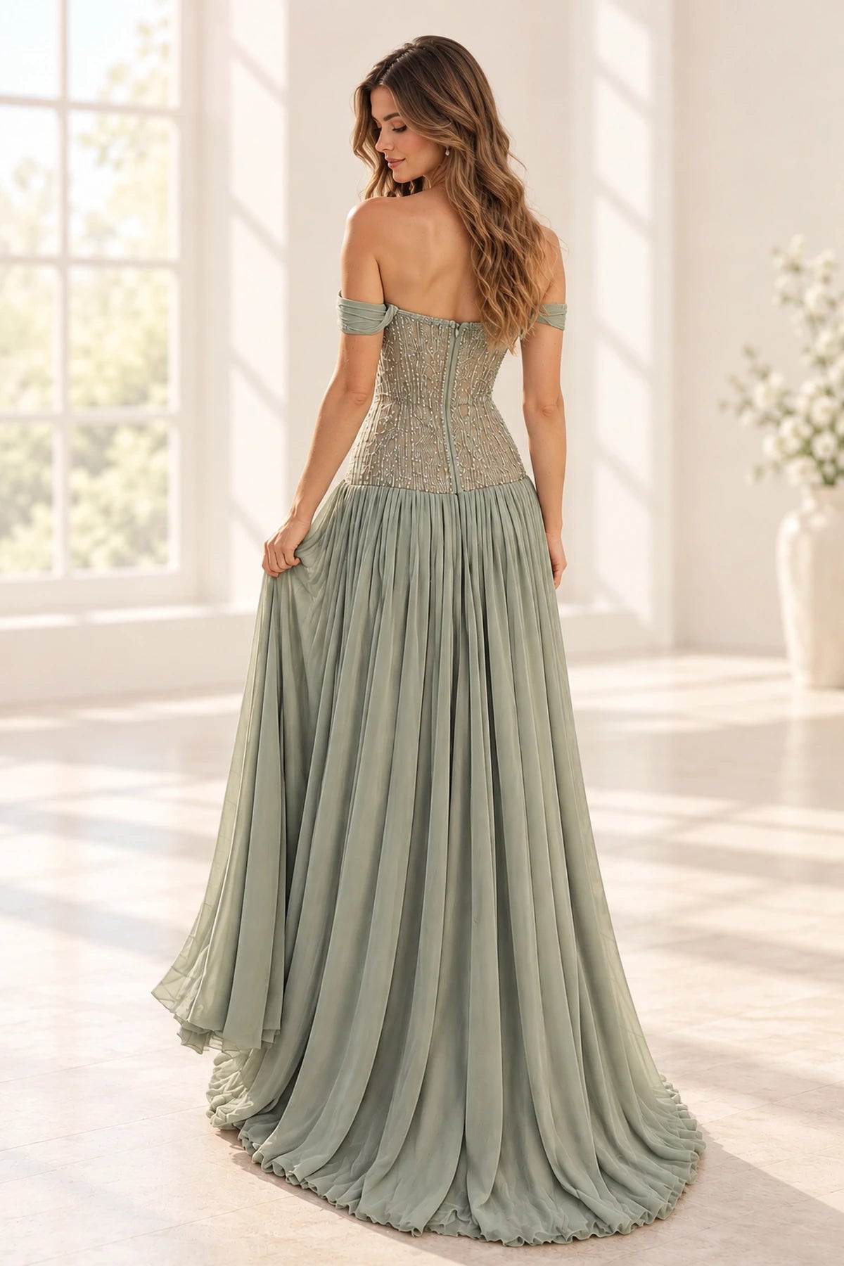 Sage green chiffon A-line prom dress back view featuring off-the-shoulder sleeves, intricate beaded corset embroidery, center zipper and flowing floor-length skirt