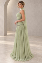 Sage green chiffon A-line prom dress with a strapless beaded neckline, ruched fitted bodice, flowing cape back and floor-length pleated skirt, side view