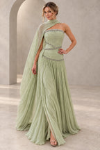 Elegant sage green chiffon prom dress featuring a strapless beaded bodice, asymmetrical cape draping, sparkling waist details and flowing A-line skirt