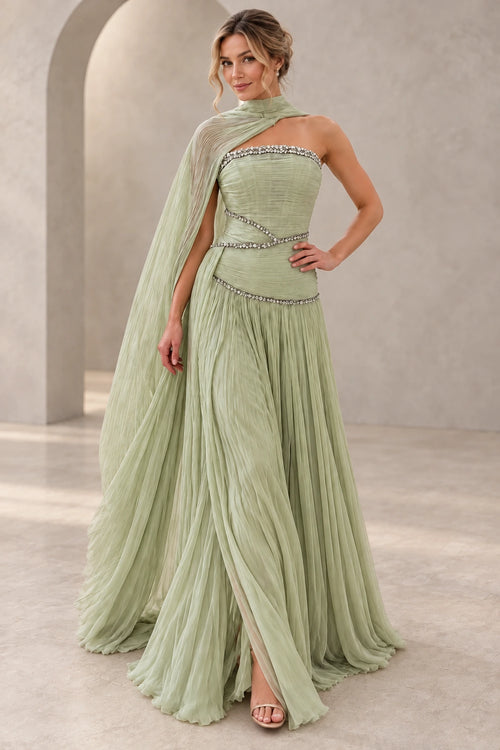 Elegant sage green chiffon prom dress featuring a strapless beaded bodice, asymmetrical cape draping, sparkling waist details and flowing A-line skirt