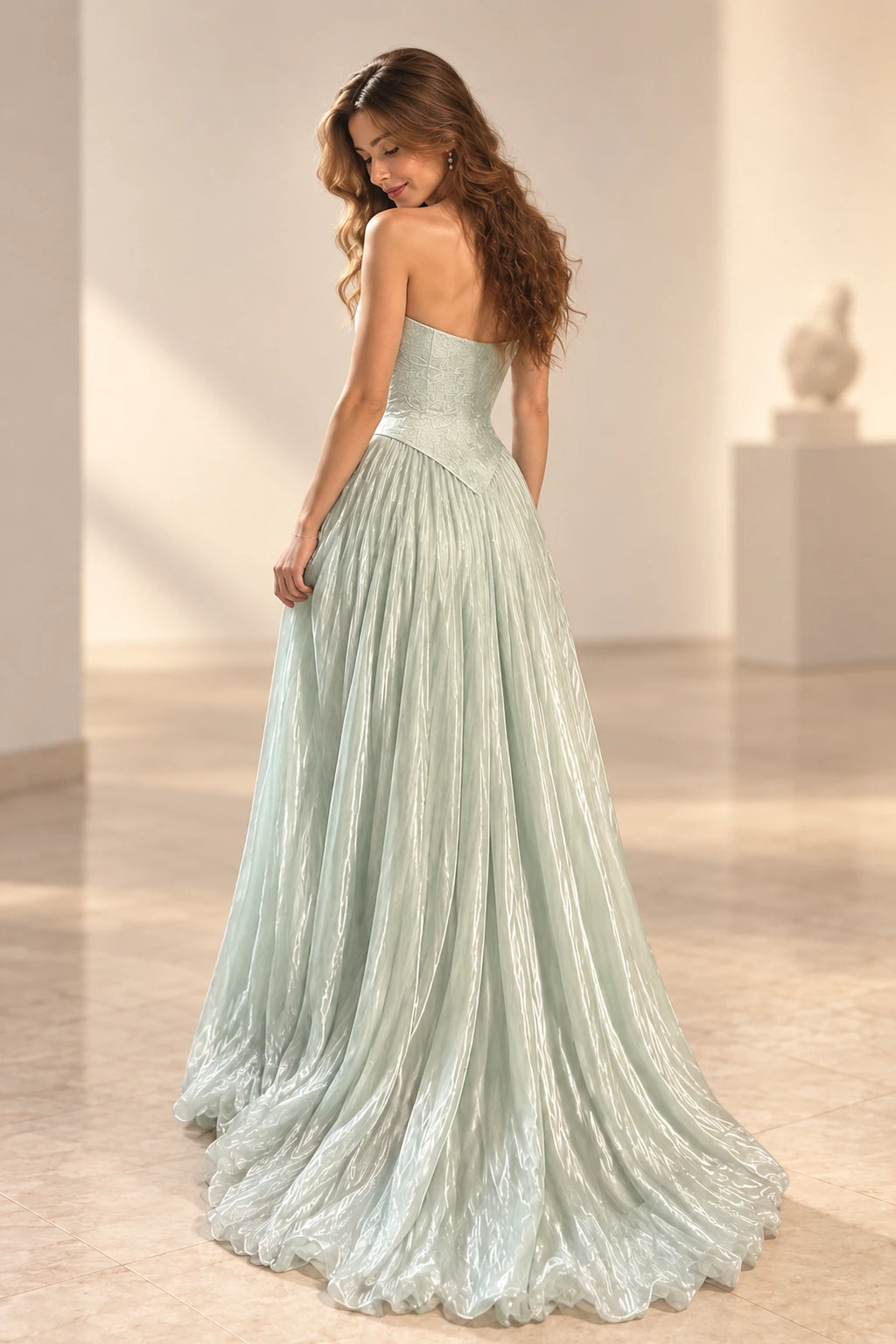 Ice blue chiffon prom dress back view featuring a strapless low back, fitted bodice, pointed waist and soft flowing A-line skirt