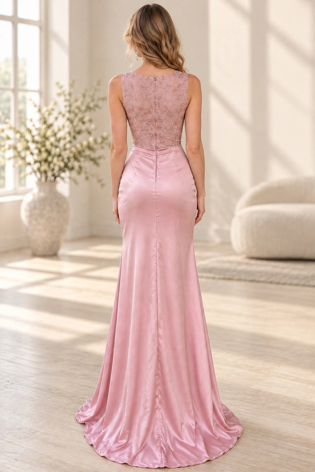 Dusty rose satin mermaid wedding guest dress back view featuring a round neckline, sleeveless floral beaded bodice, center zipper and floor-length skirt with train