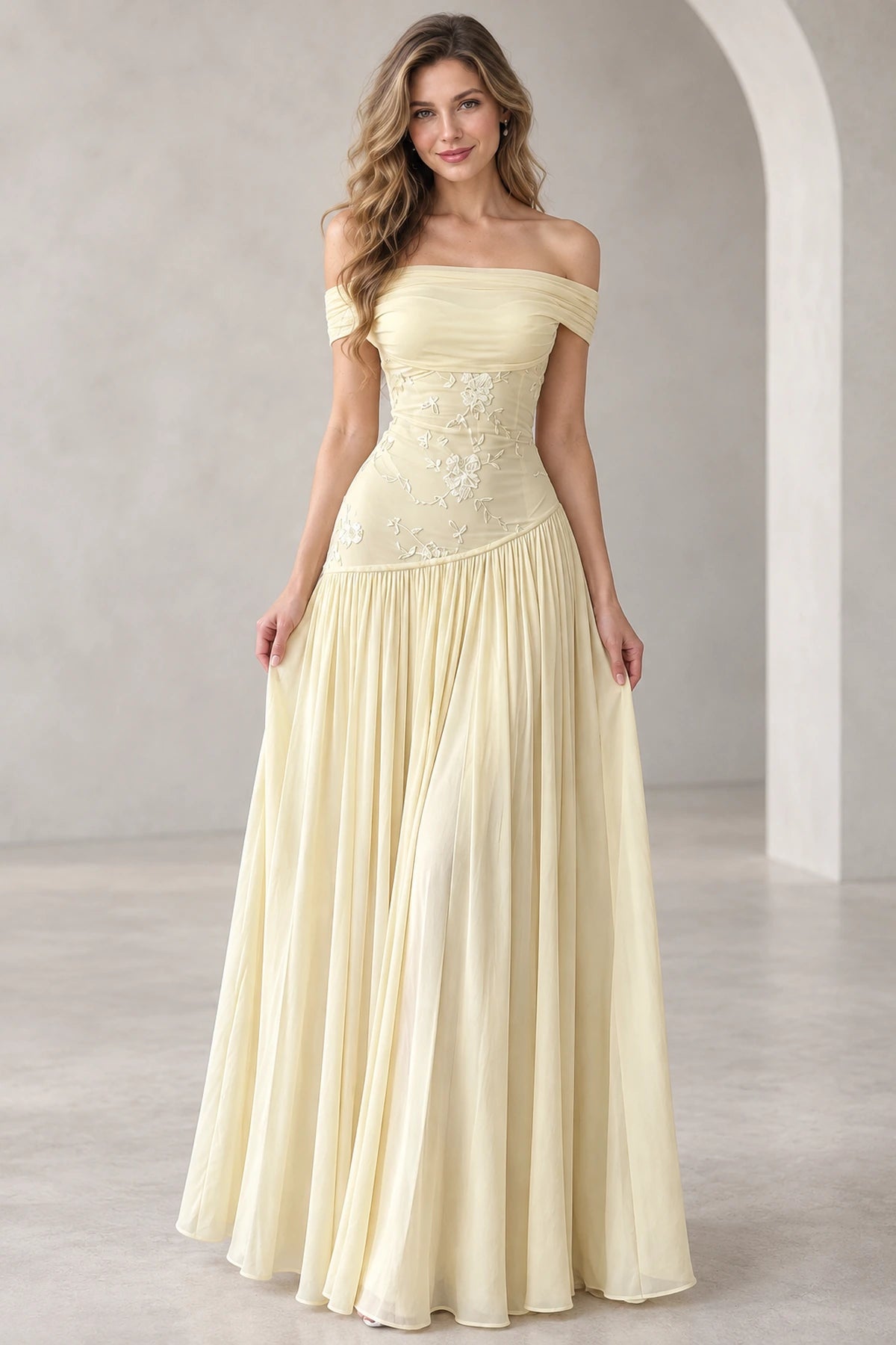 Light yellow chiffon A-line prom dress featuring an off-the-shoulder draped neckline, floral embroidered fitted bodice, and flowing floor-length pleated skirt.