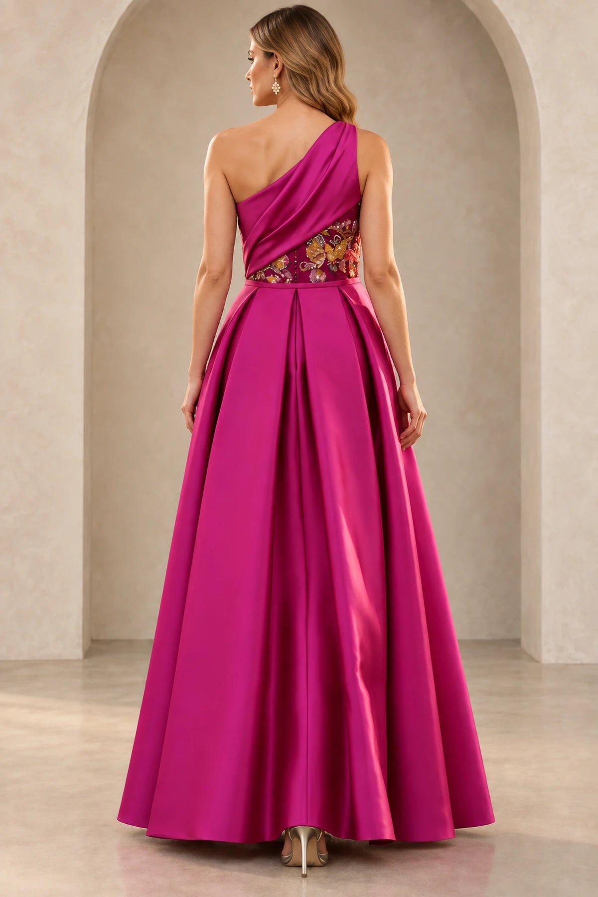 Back view of fuchsia Mother of the Bride Dress with one-shoulder draping and full A-line overskirt