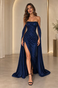 Navy blue sequin mermaid prom dress front view featuring a strapless neckline, ruched fitted bodice, high slit and dramatic flowing chiffon cape sleeves