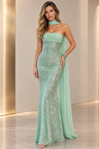 Mint green sequin mermaid prom dress front view featuring a strapless neckline, fitted sparkling bodice, flowing chiffon neck scarf and floor-length skirt