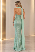 Mint green sequin mermaid prom dress back view showing a strapless fitted bodice, center zipper, open upper back and long flowing chiffon scarf