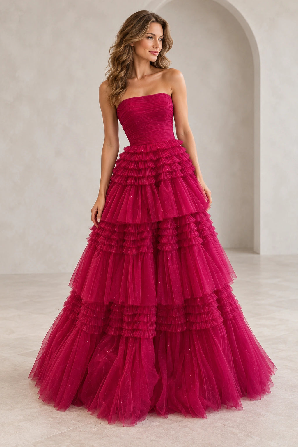 Hot pink glitter tulle A-line prom dress with straight strapless neckline, ruched bodice and voluminous tiered ruffle floor length skirt by Graceprom