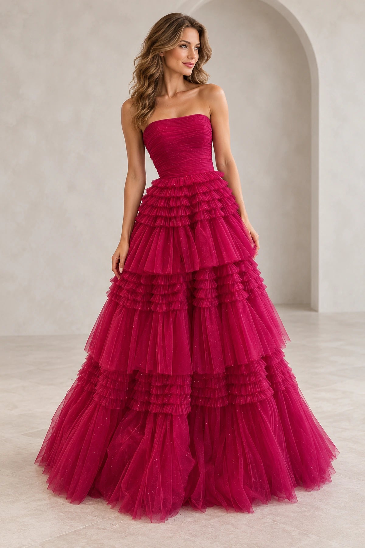 Hot pink glitter tulle A-line prom dress with straight strapless neckline, ruched bodice and voluminous tiered ruffle floor length skirt by Graceprom