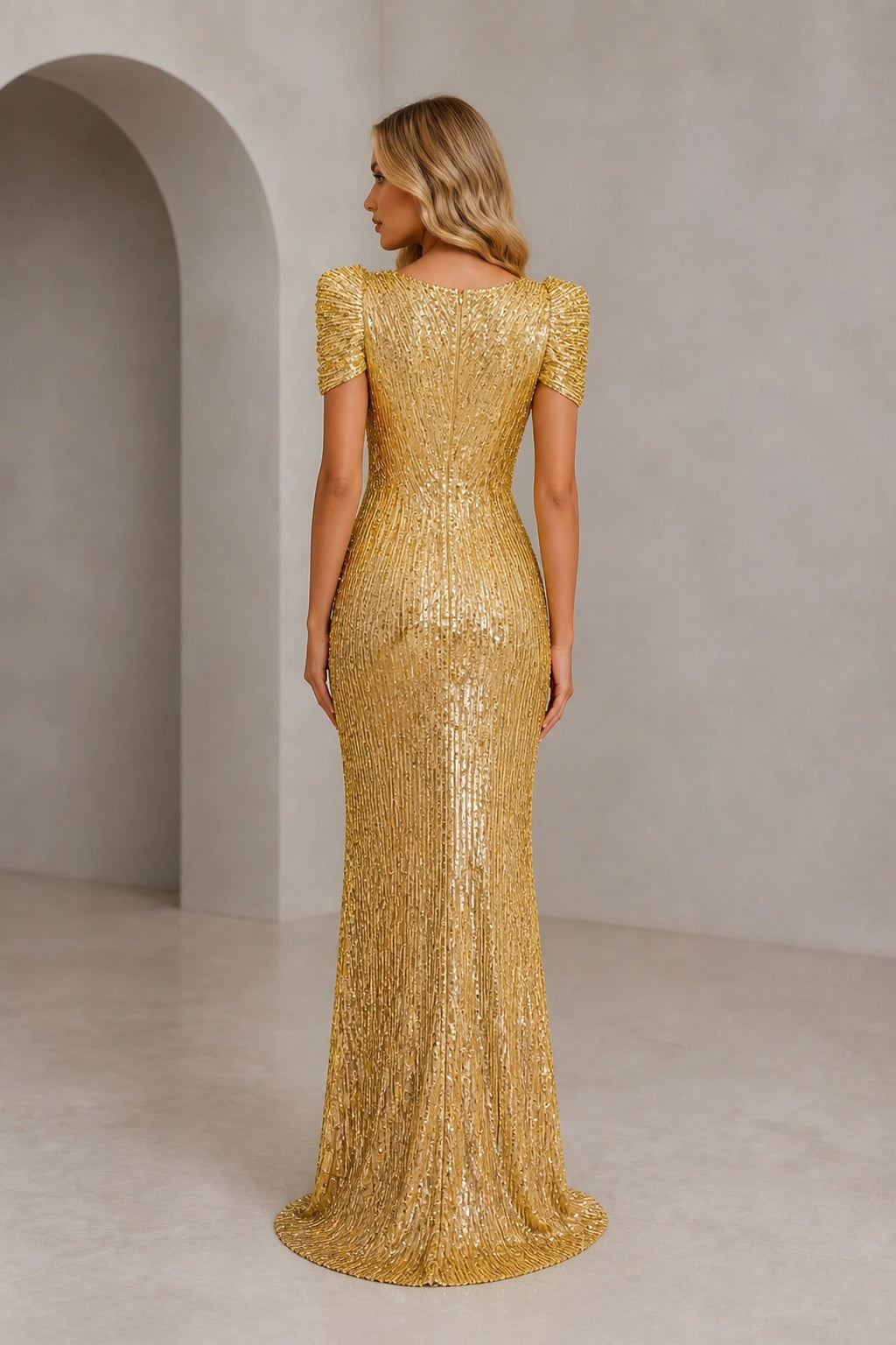 Back view of gold sequin evening dress with short sleeves, closed back and fitted floor-length silhouette