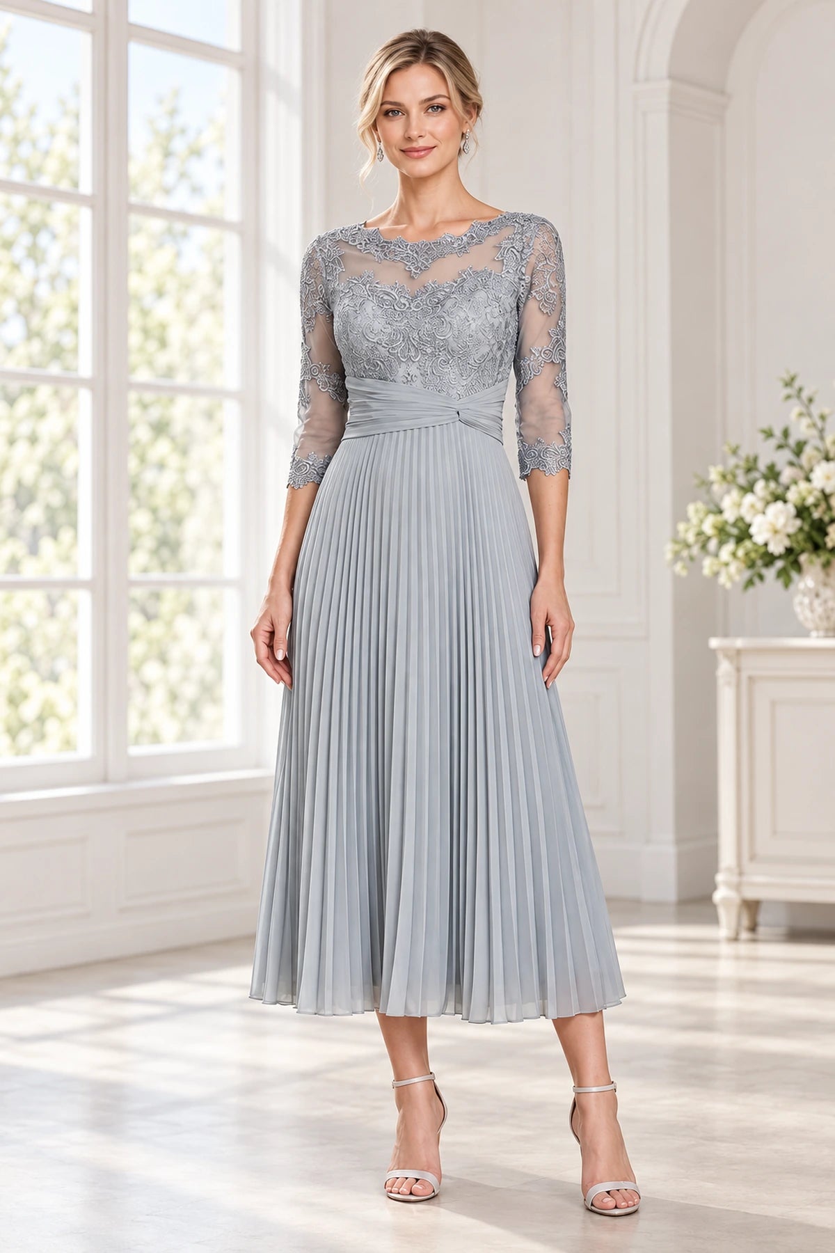 Front view of a gray tea-length wedding guest dress with illusion neckline lace bodice 3/4 sheer sleeves and pleated A-line skirt