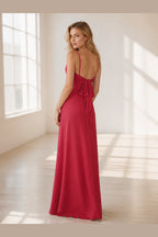 Berry red floor-length wedding guest dress with sweetheart neckline, spaghetti straps, pleated bodice, front slit, and low V bow back.