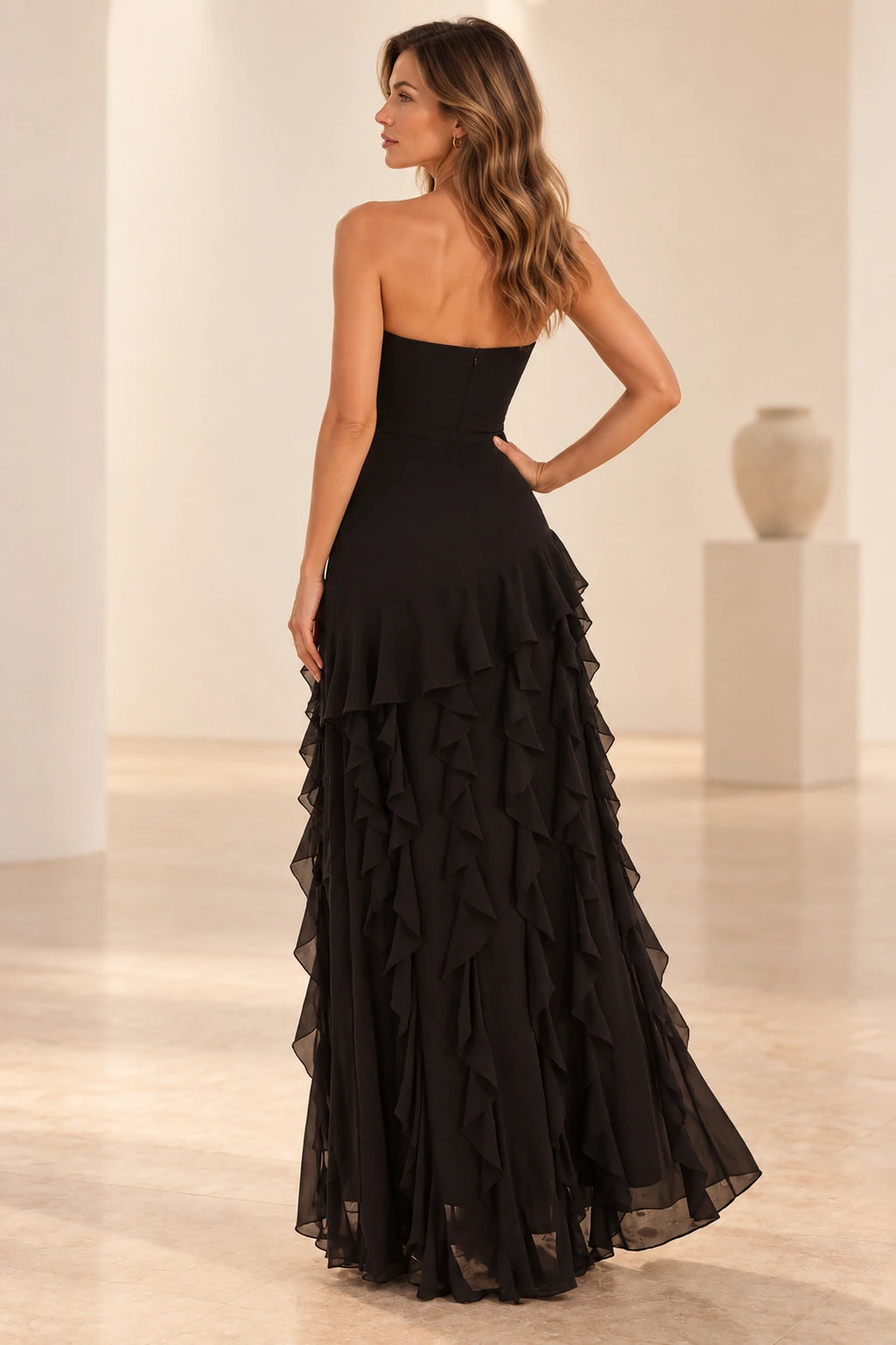 Back view of Graceprom black strapless mermaid prom dress with center back zipper and layered ruffle train
