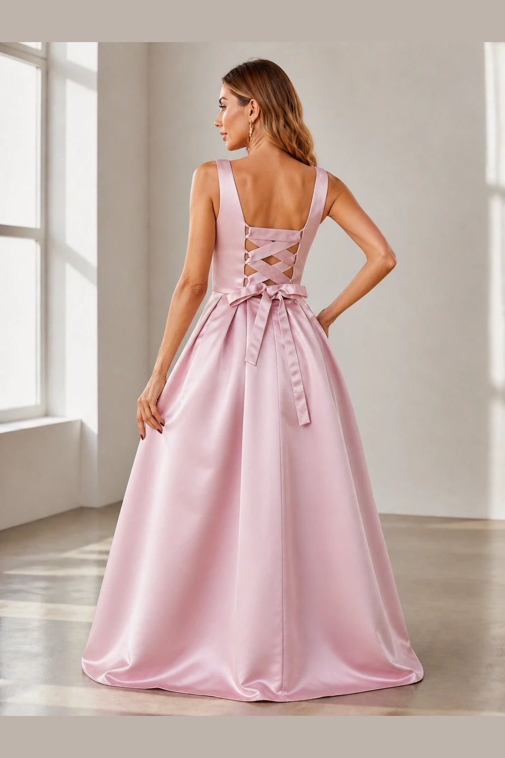Back view of blush pink floor-length prom dress with lace-up back and bow detail by GraceProm