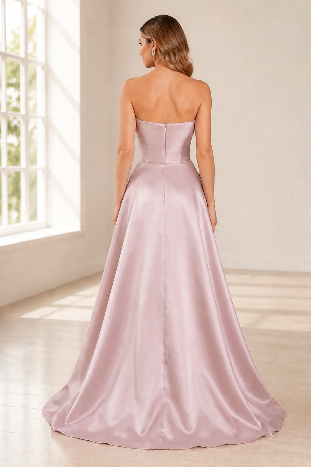 Back view of blush pink strapless floor-length wedding guest dress with zipper