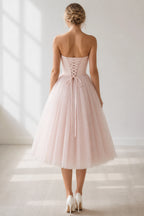 Back view of blush pink strapless bridesmaid dress with lace-up corset back by GraceProm