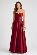 Burgundy satin wedding guest dress with cowl neckline, spaghetti straps and A-line floor-length skirt by GraceProm