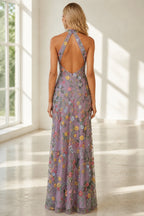 Back view of floral floor-length wedding guest dress with halter straps and dramatic open back by GraceProm