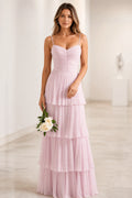 Light pink wedding guest dress with sweetheart neckline, spaghetti straps, ruched bodice and tiered floor-length skirt