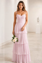 Light pink wedding guest dress with sweetheart neckline, spaghetti straps, ruched bodice and tiered floor-length skirt