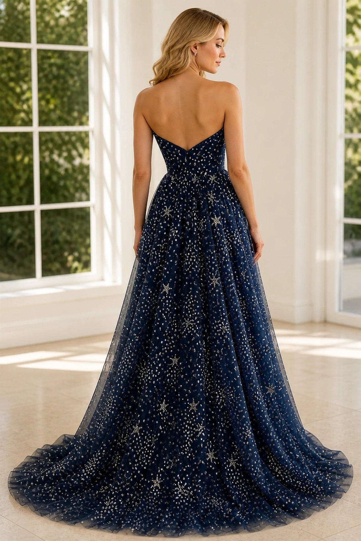 Back view of navy sparkling A-line prom dress with low V-back and full skirt